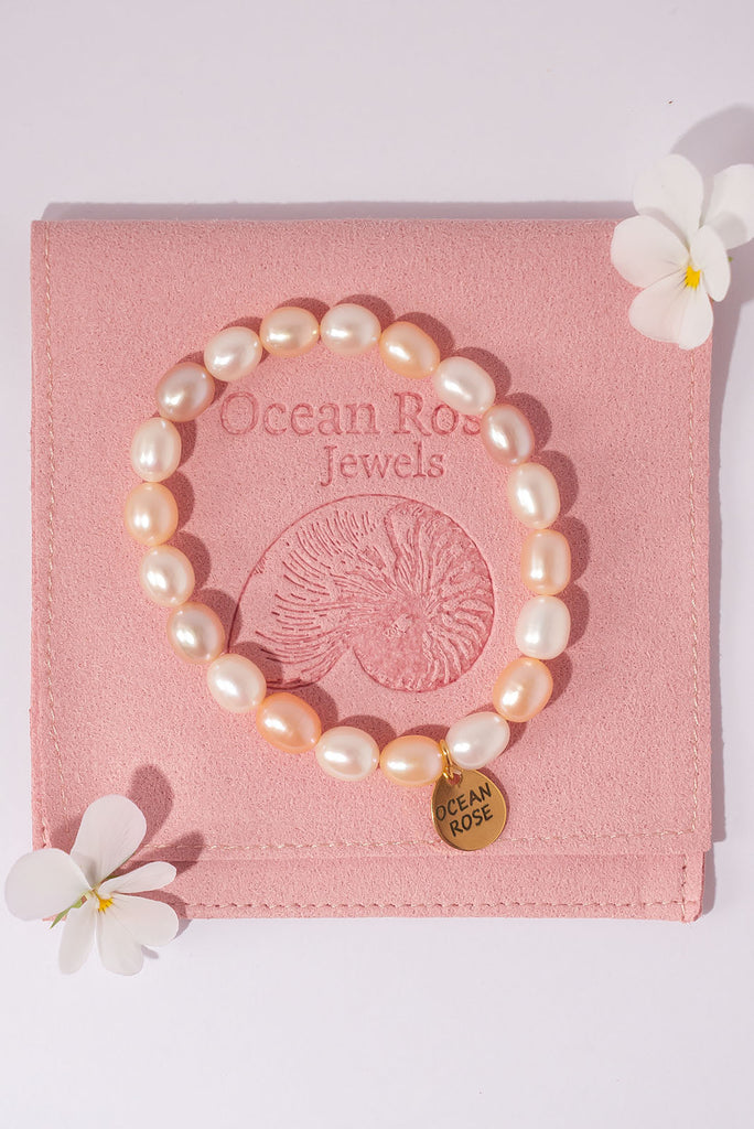 This beautiful pearl bracelet features pastel peachy pink and soft white pearls.