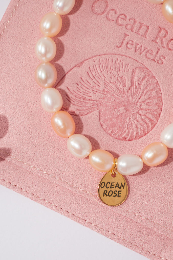 This beautiful pearl bracelet features pastel peachy pink and soft white pearls.