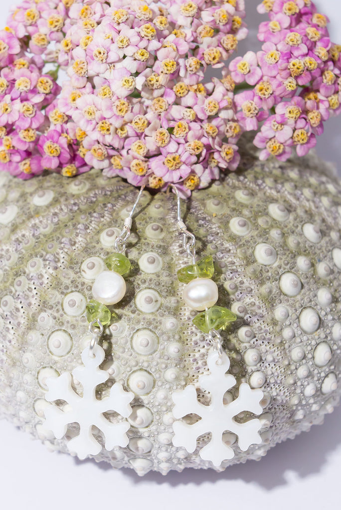 A snowflake on a South Pacific island, imagine that and this pretty carved mother of pearl snowflake has a tiny sparkling green Peridot bead as a highlight so dream on wearing our newest earring style.