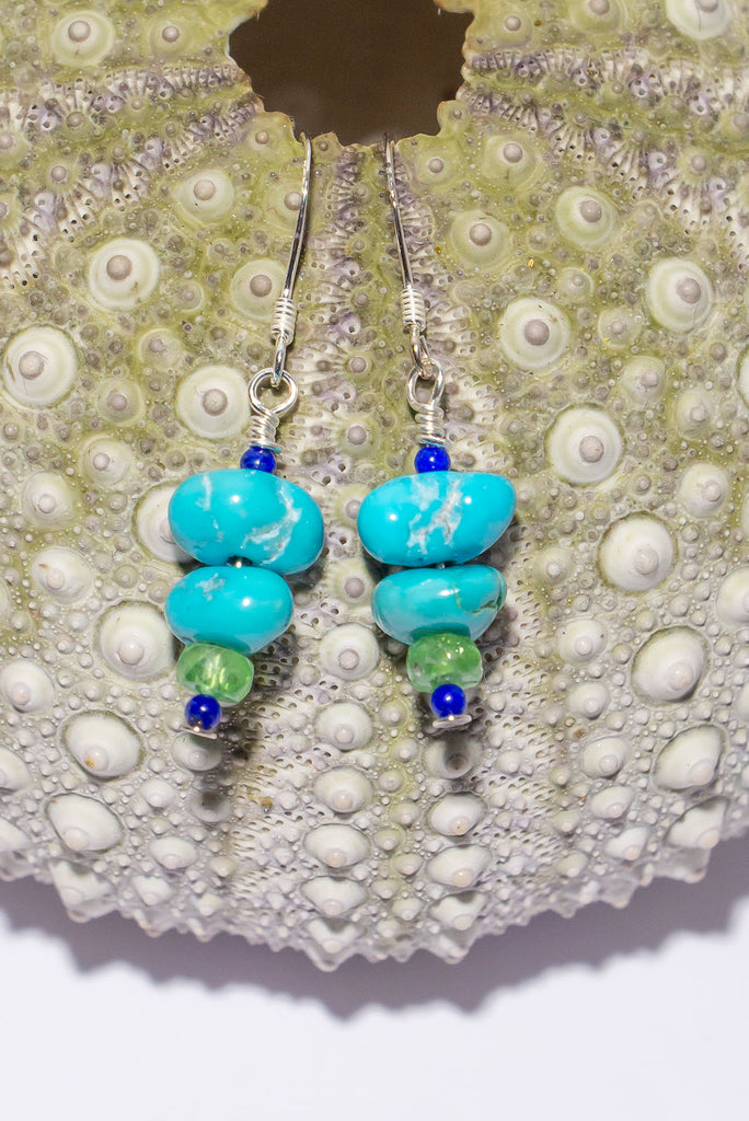 Tumbled Lone Mountain Turquoise in beautiful organic shapes is complimented by the beautiful green of tsavorite and the deep midnight blue of lapis lazuli.