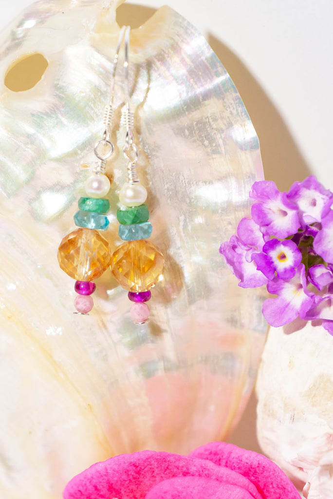 A delicate gemstone earring with a kaleidoscope of colours.