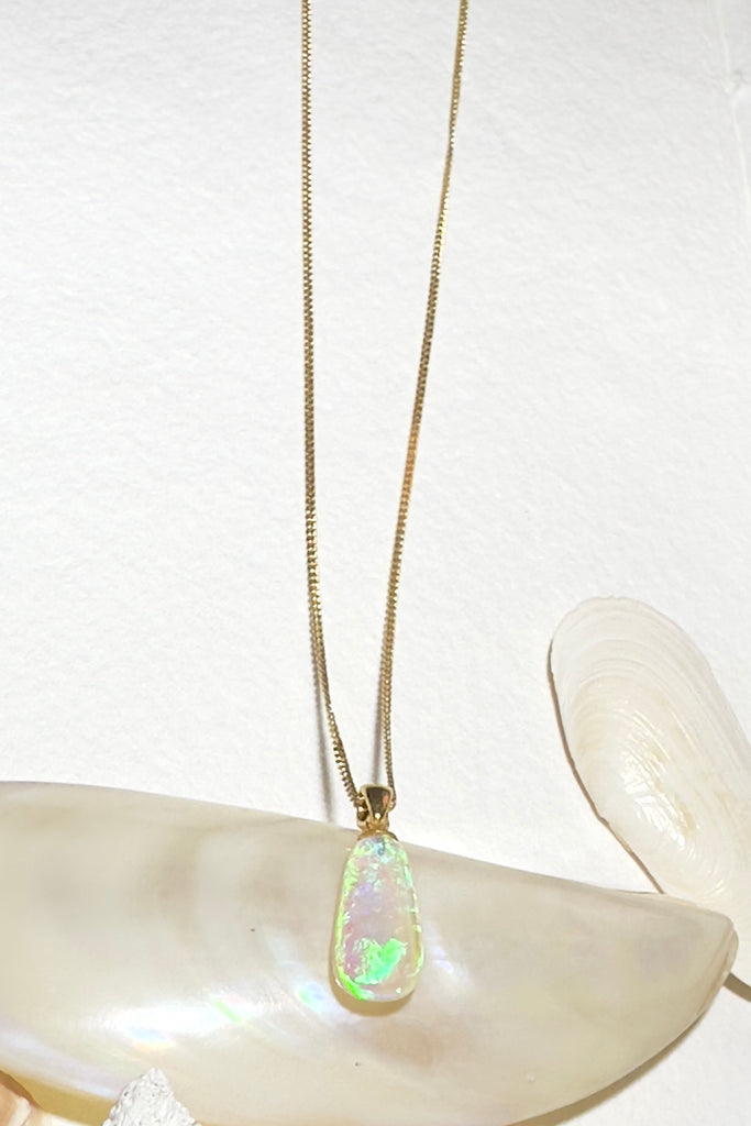 this clear Australian crystal Opal pendant is shot through with bright green, sky blue and soft mauve, its all the colours of nature and the sky.