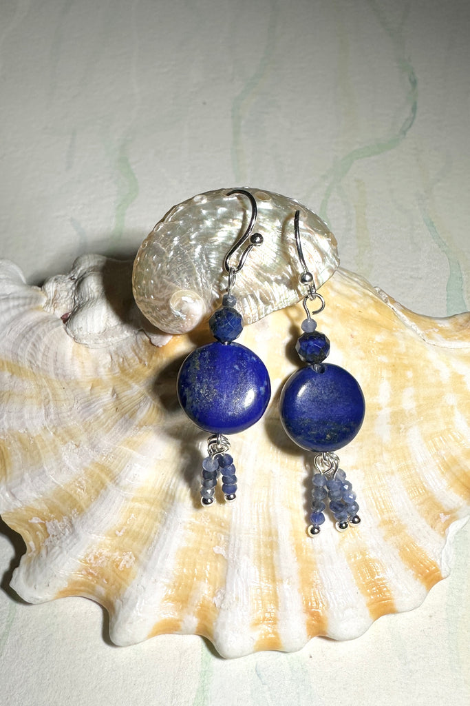 these earrings with dark blue Lapis Lazuli beads have three little tassels of paler blue Sodalite beads dancing below.&nbsp;