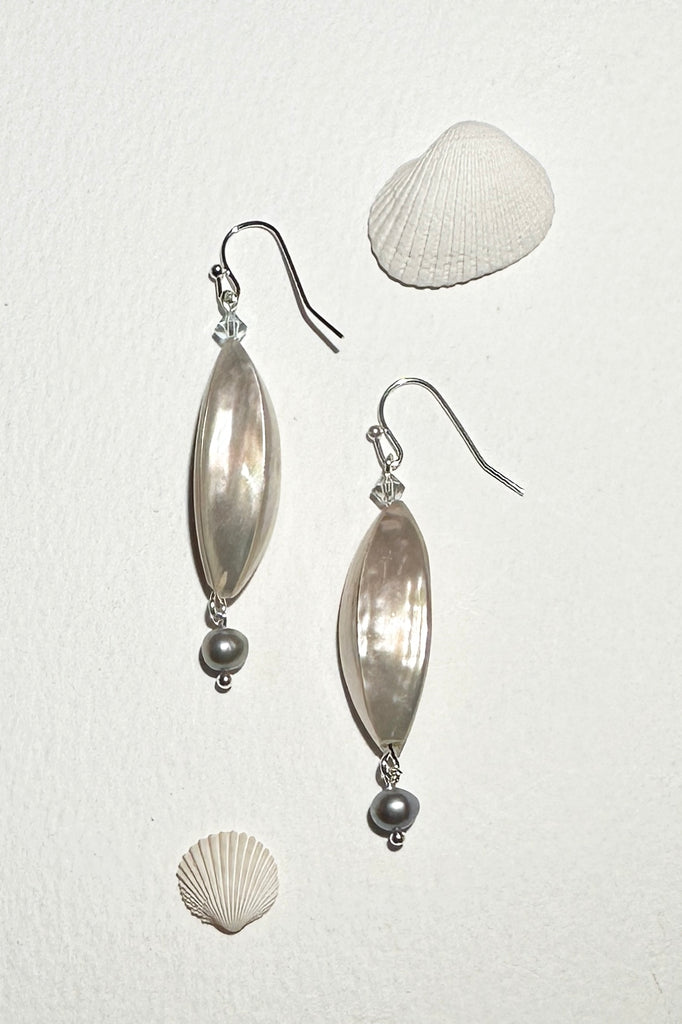 Add a pop of seashore seafoam to your summer outfit, cut from pearly shell with a happy swinging grey pearl at the base.

Cut from pearly shell and made into a triangle shape.
Silvery grey freshwater Pearl
Made in Noosa Australia.