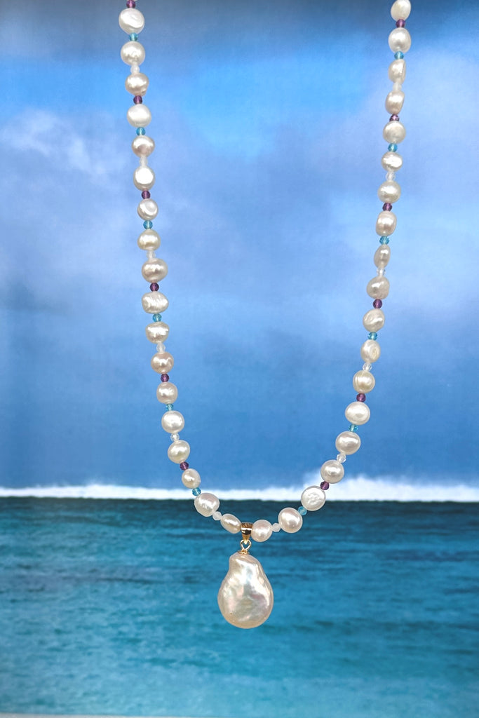 A pearl necklace with a South Pacific twist, luminescent creamy white pearls interspaced with turquoise, pink and white CZ beads, feel the calm of the islands.&nbsp;

Freshwater pearls.