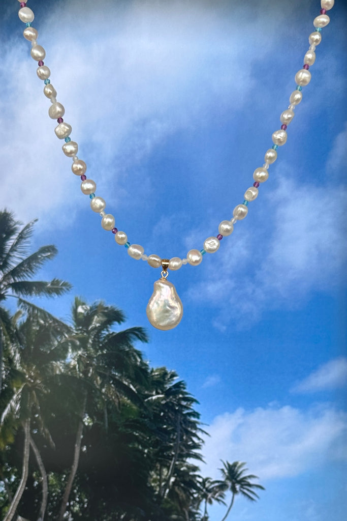 A pearl necklace with a South Pacific twist, luminescent creamy white pearls interspaced with turquoise, pink and white CZ beads, feel the calm of the islands.&nbsp;

Freshwater pearls.