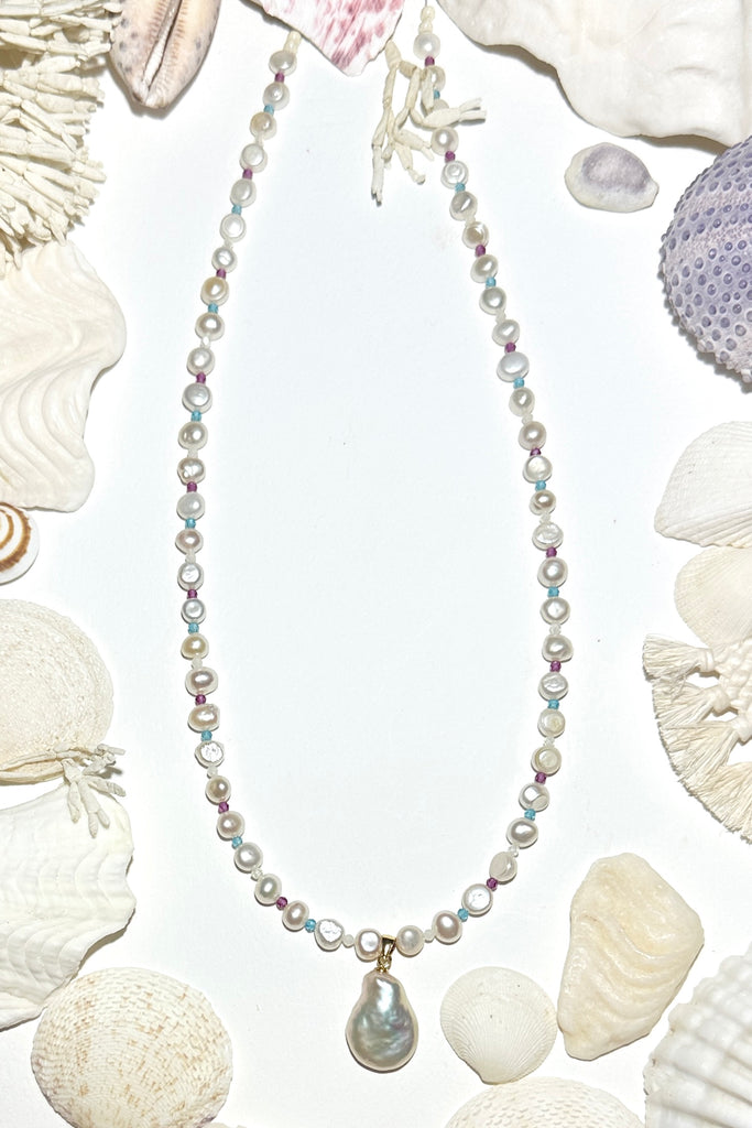 A pearl necklace with a South Pacific twist, luminescent creamy white pearls interspaced with turquoise, pink and white CZ beads, feel the calm of the islands.&nbsp;

Freshwater pearls.