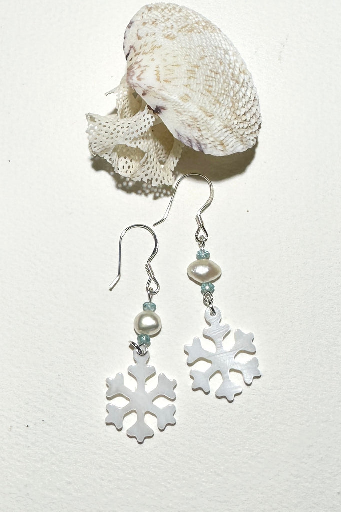 Hand cut Mother of Pearl snowflake earrings.
A small freshwater pearl.