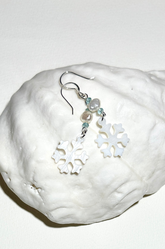 Hand cut Mother of Pearl snowflake earrings.
A small freshwater pearl.