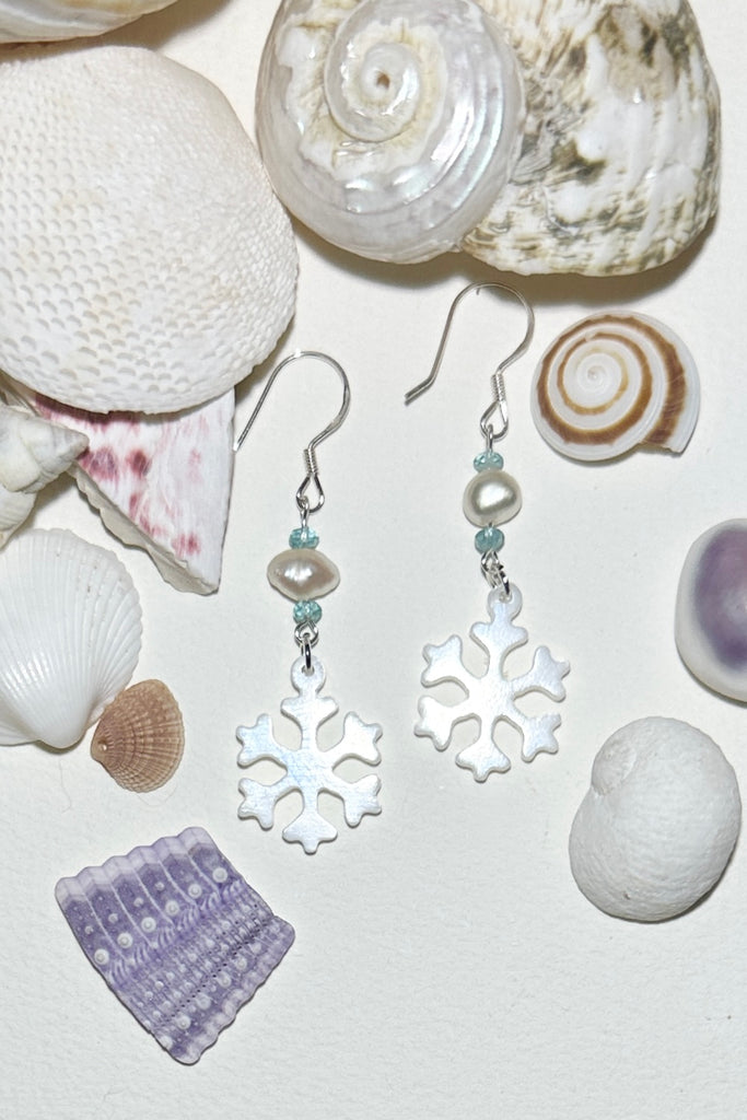 Hand cut Mother of Pearl snowflake earrings.
A small freshwater pearl.