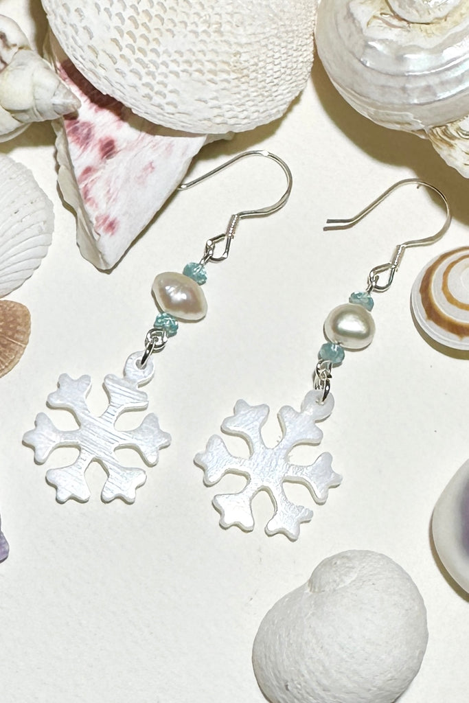 Hand cut Mother of Pearl snowflake earrings.
A small freshwater pearl.