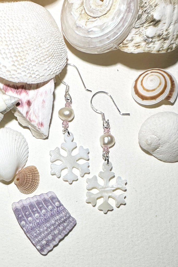 Hand cut Mother of Pearl snowflake earrings.
A small freshwater pearl.