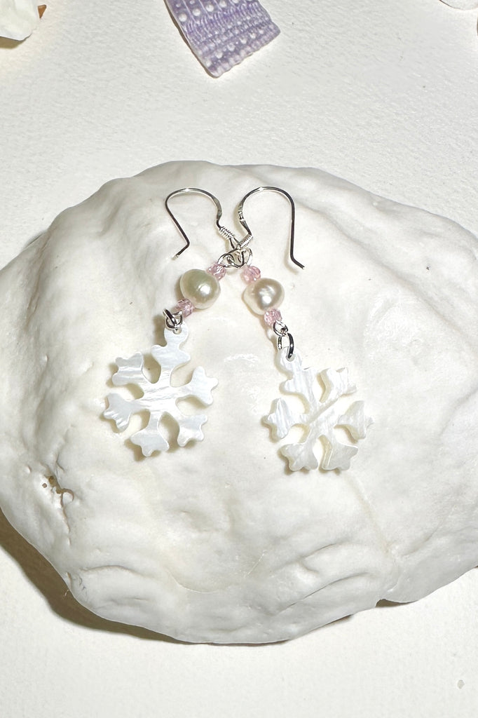 Hand cut Mother of Pearl snowflake earrings.
A small freshwater pearl.