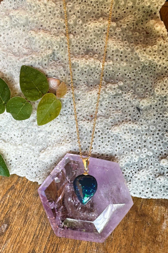 This Australian black opal pendant has bright blue and teal flash deep in the stone.