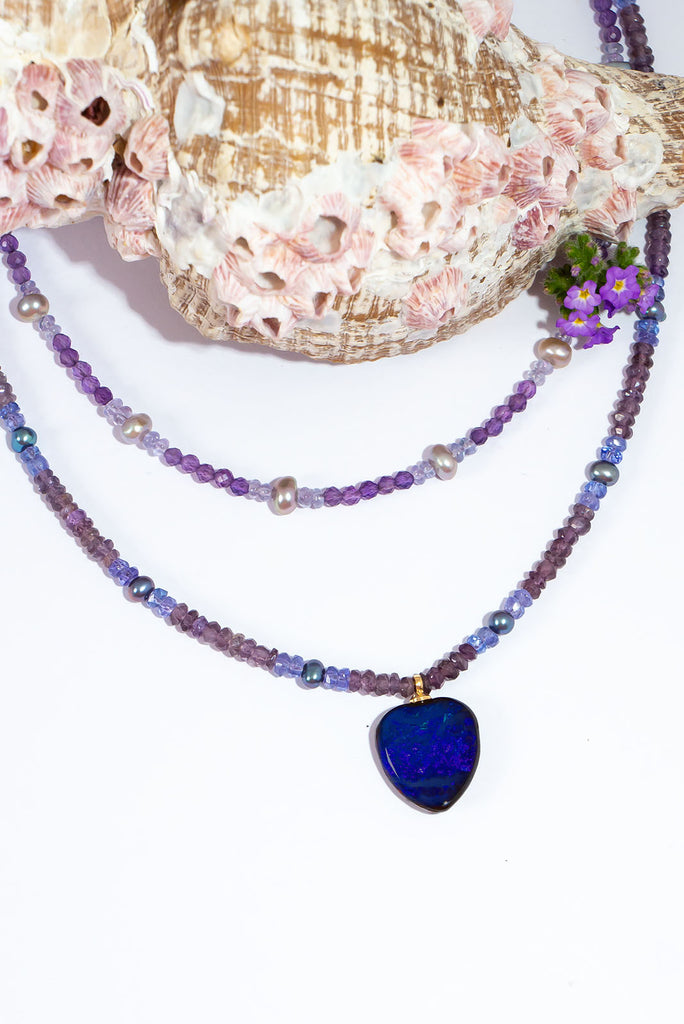 Get lost in the mesmerizing shades of violet, lavender and deepest purple featured in this gorgeous gemstone & opal necklace.