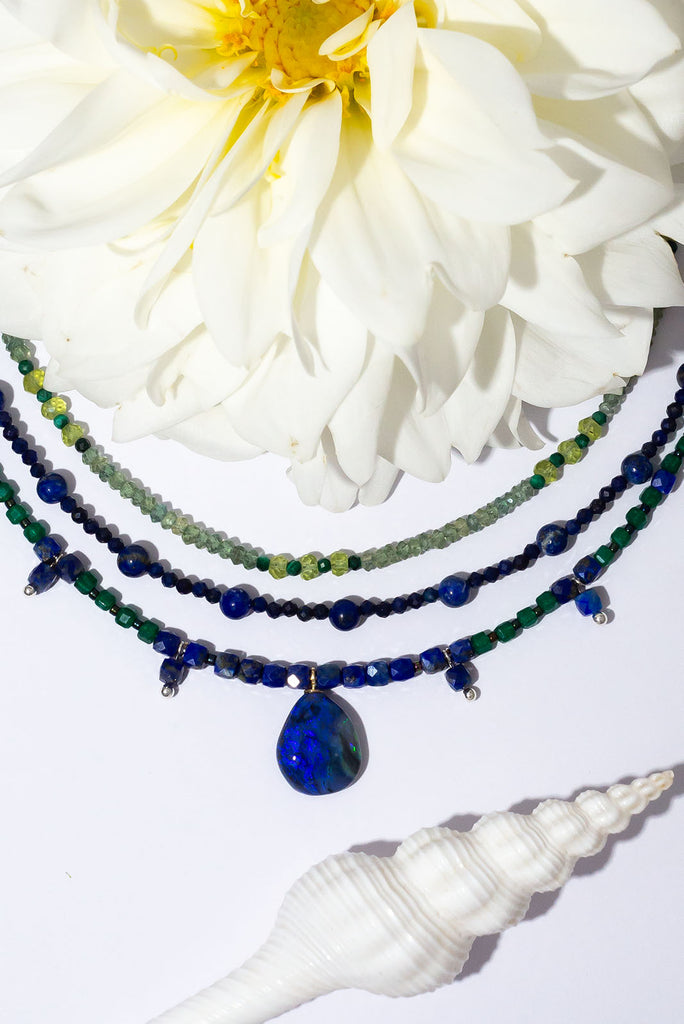 Get lost in the swirling indigo hues of this enchanting necklace.