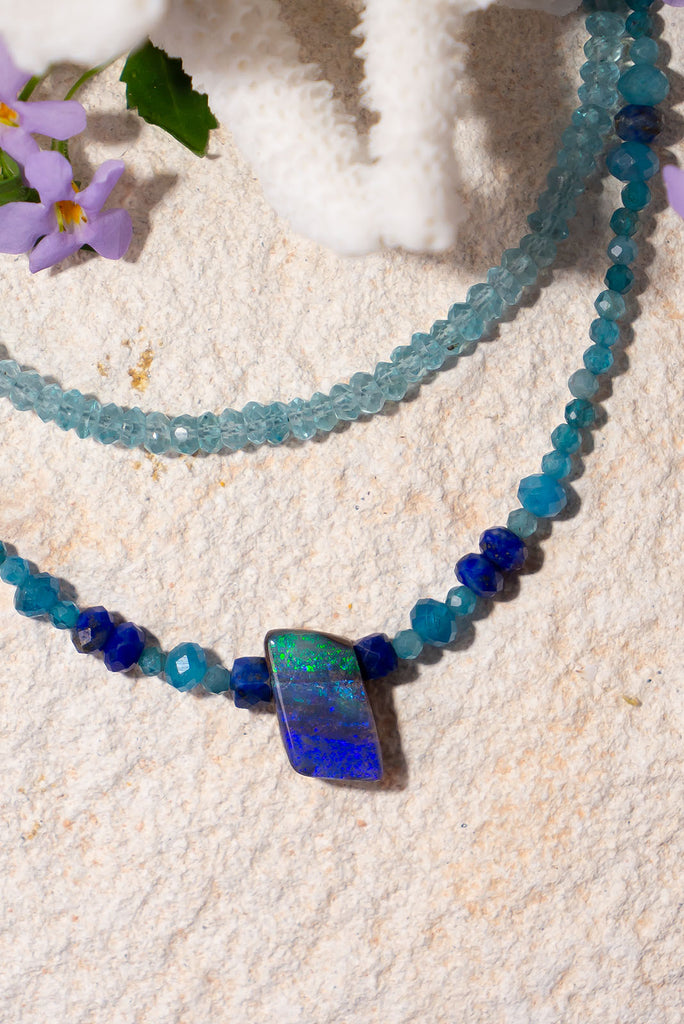 Deep blue crystal ocean flowing to green glinting sea, a tiny slice of cobalt and green. Strung on an Apatite bead necklace with beads of blue Lapis Lazuli adding a contrast.