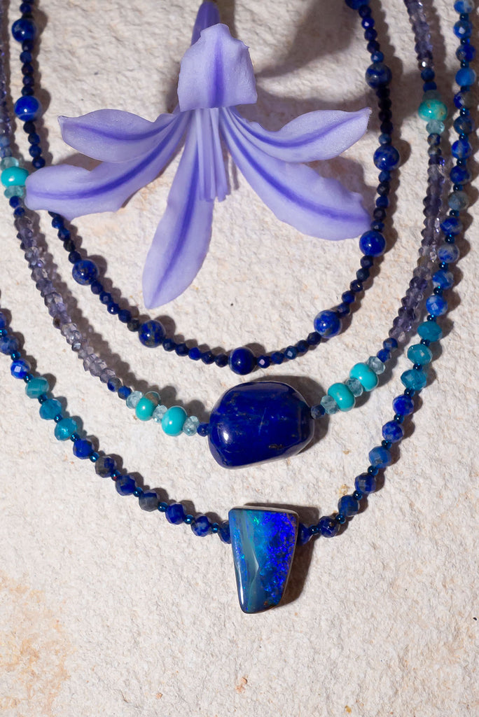 Deep sea blues and aqua sea greens sparkle within this stunning opal & gemstone necklace.