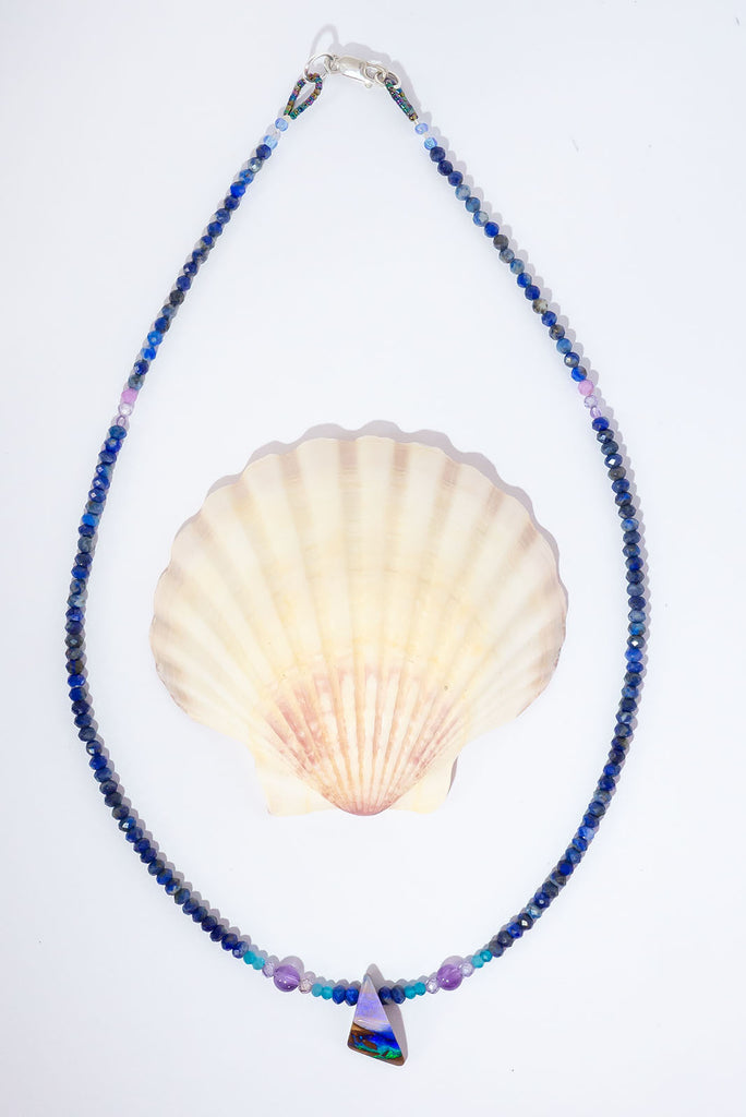 A bright splash of blue, a river of brightest green and an amethyst sky. A solid opal with the intensity of bright colour that is absolutely unique, on a deep blue Lapis Lazuli faceted bead necklace.