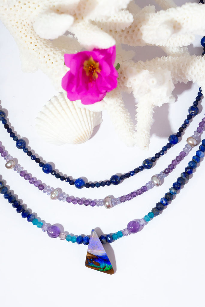 A bright splash of blue, a river of brightest green and an amethyst sky. A solid opal with the intensity of bright colour that is absolutely unique, on a deep blue Lapis Lazuli faceted bead necklace.