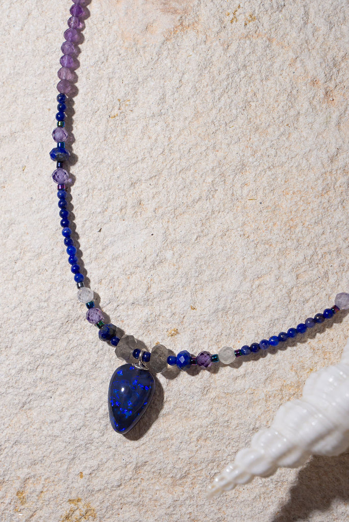 Get lost in the swirling indigo hues of this enchanting necklace.