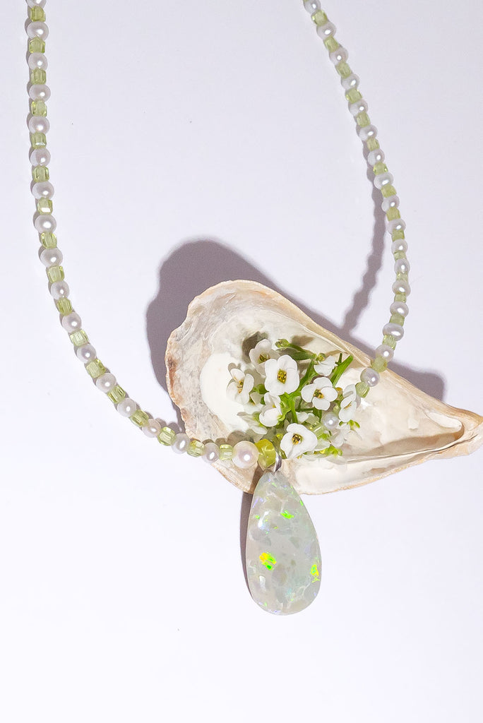 Peridot and Pearls, green, gold and blue flashes across the opal in a magical dance of colour. So mystical and chic.