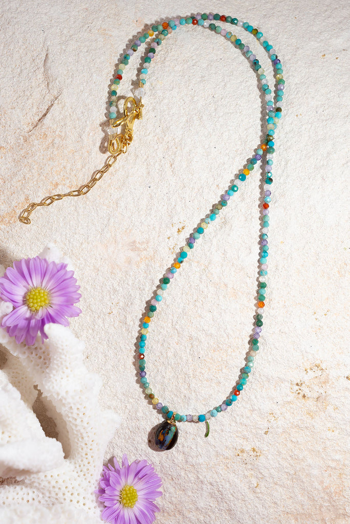 This gorgeous necklace features a delicate kaleidoscope of gemstone.