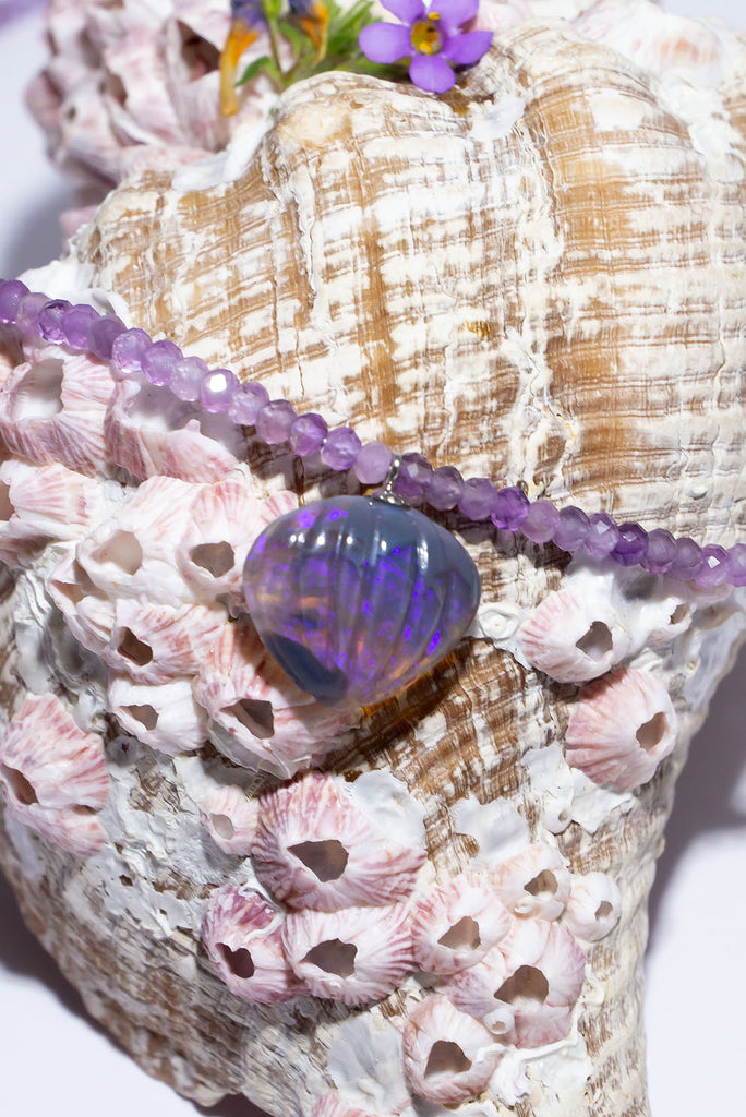 The delicate violet purple hue of this captivating hand carved Australian Crystal Opal is perfectly complimented by tonal amethyst beads.