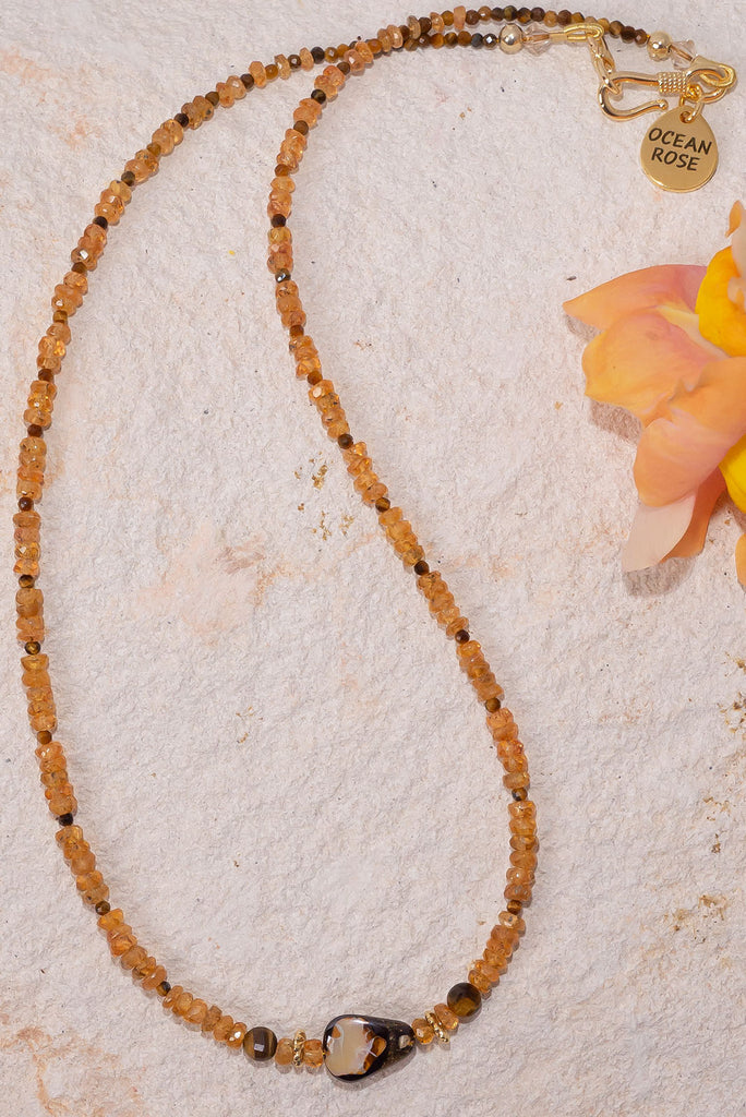 This radiant gemstone &amp; opal bead necklace features saturated golden hues and a unique boulder opal feature bead.