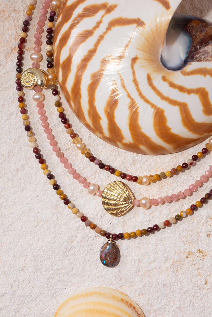 A magical Australian Boulder Opal is complimented the gorgeous earthy hues of Australian mookaite.