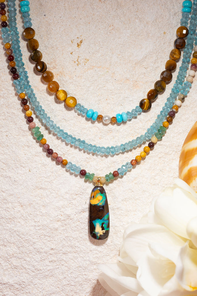 Reminiscent of images of earth from space this gemstone & opal necklace will have you enthralled.