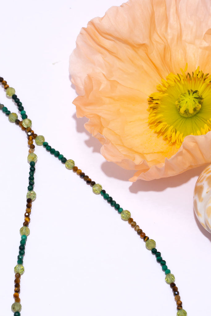 This delicate gemstone necklace features forest green, leafy green and earthy browns.