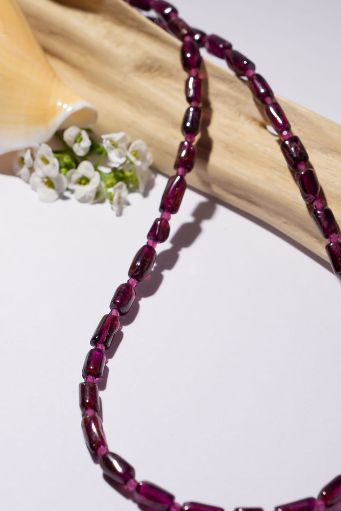 This delicate necklace is all about the beautiful deep plum red of its garnet beads.