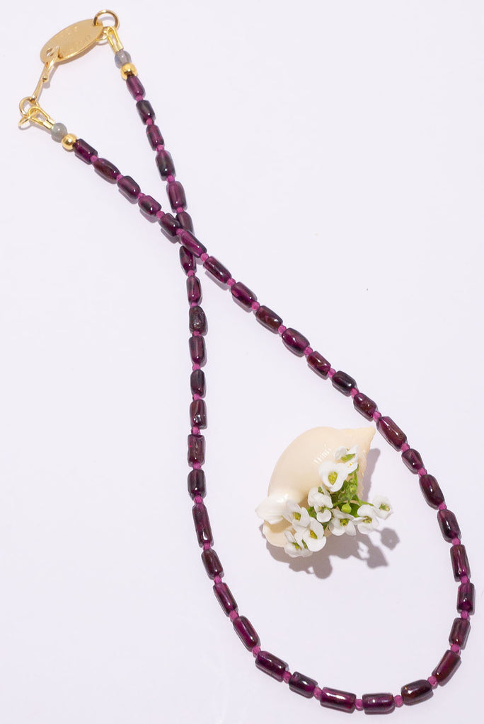 This delicate necklace is all about the beautiful deep plum red of its garnet beads.