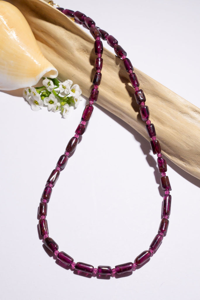 This delicate necklace is all about the beautiful deep plum red of its garnet beads.