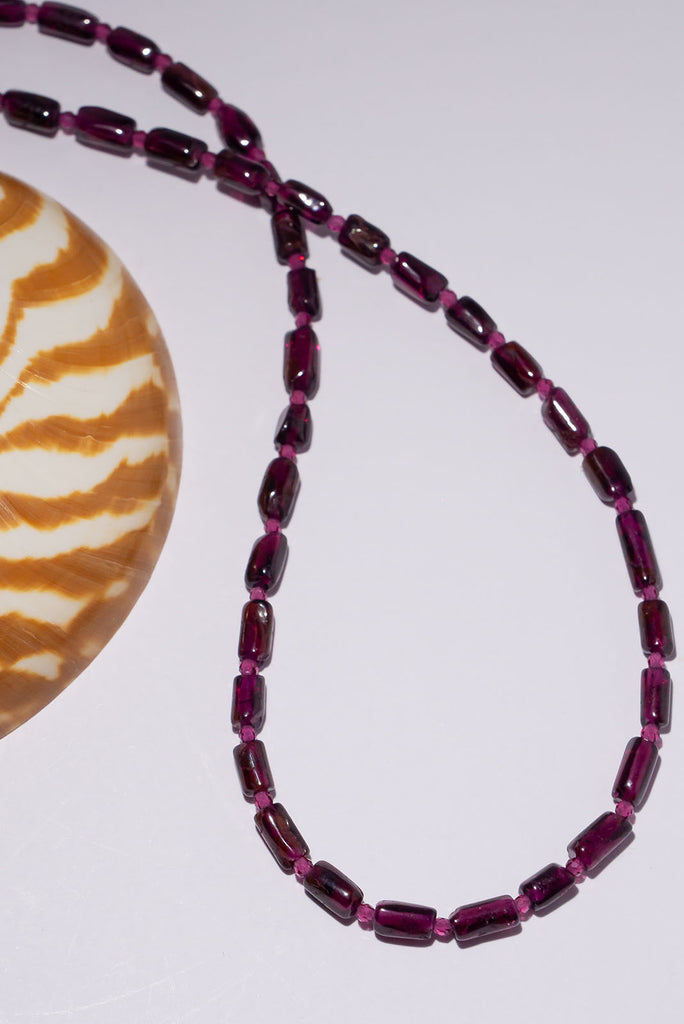 This delicate necklace is all about the beautiful deep plum red of its garnet beads.