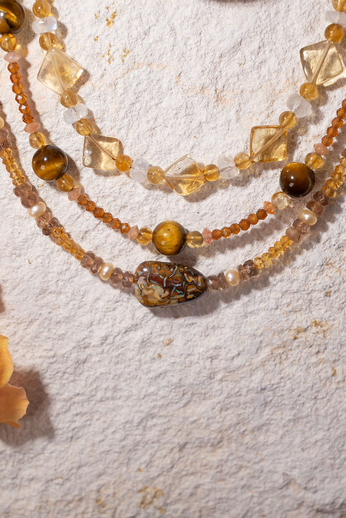 This golden toned gemstone necklaces features luminous citrine & andalustie beads and features a enchanting Australian matrix opal bead with flecks of gold &amp; green colour play.