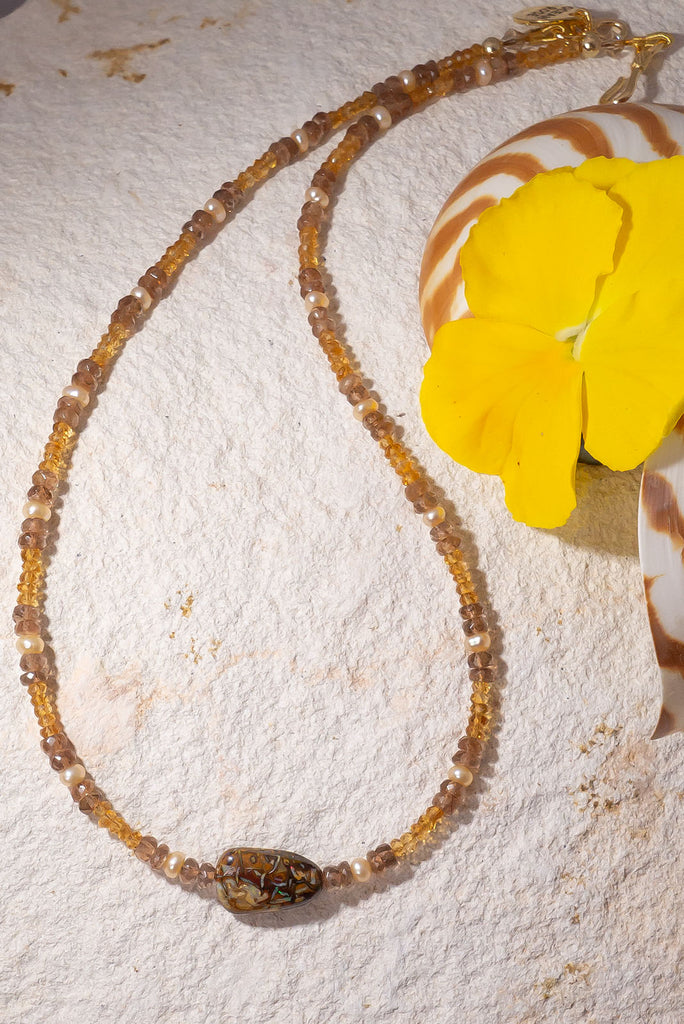 This golden toned gemstone necklaces features luminous citrine & andalustie beads and features a enchanting Australian matrix opal bead with flecks of gold &amp; green colour play.