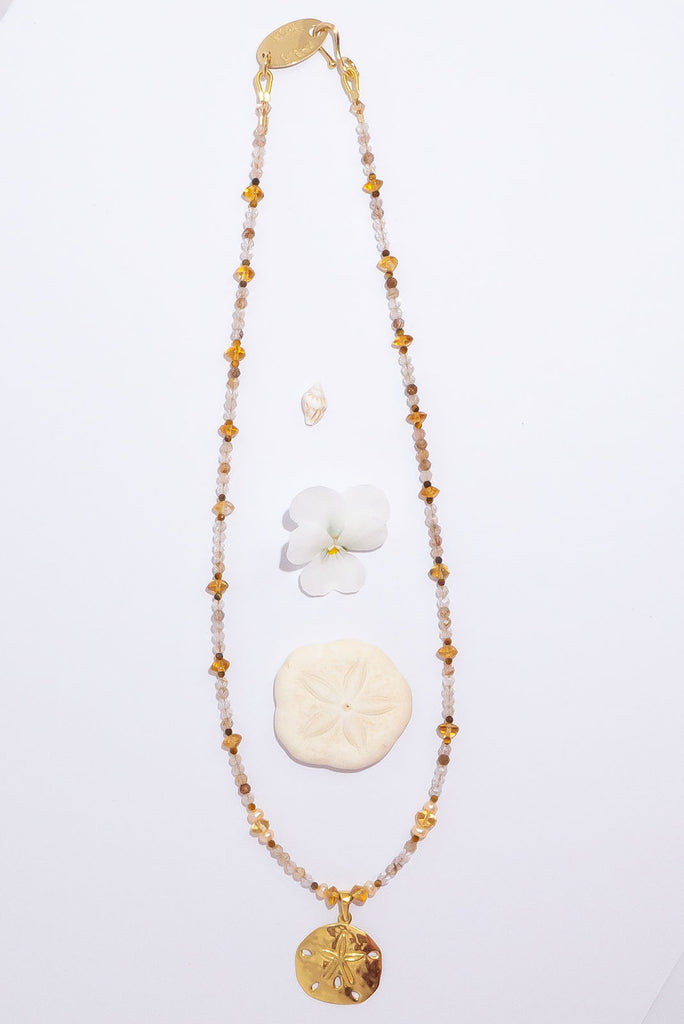 A perfect golden sand dollar set amongst sparkling golden rutile. This is a gorgeous & glowing Summer necklace.