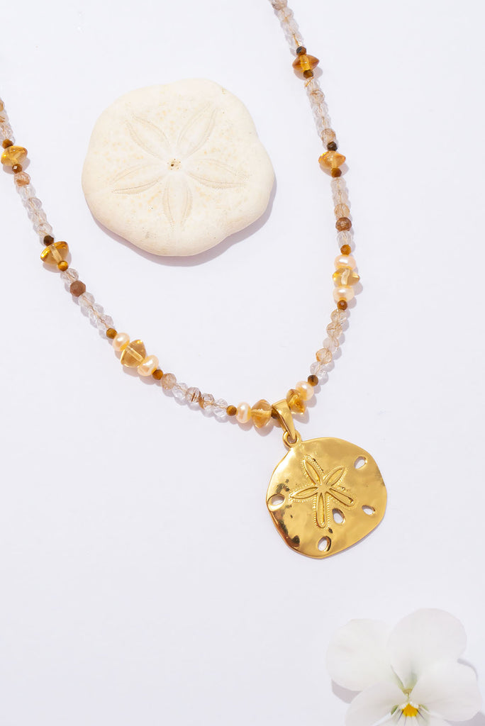 A perfect golden sand dollar set amongst sparkling golden rutile. This is a gorgeous & glowing Summer necklace.