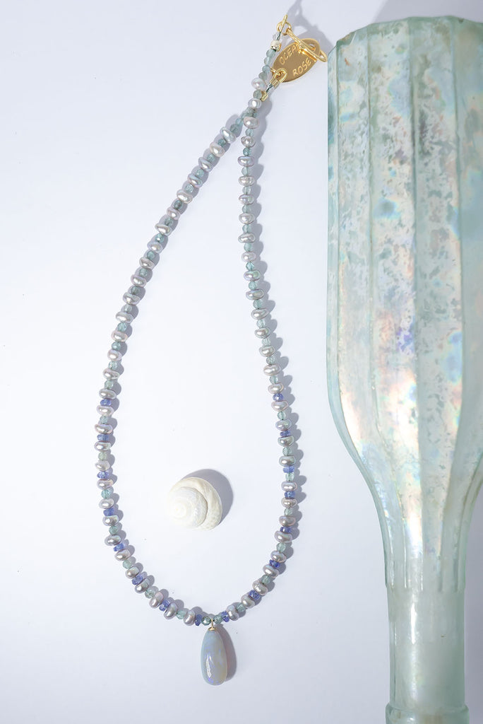 Misty grey, periwinkle blue, aquamarine and a luminous Australian opal come together to create an ethereal gemstone necklace.