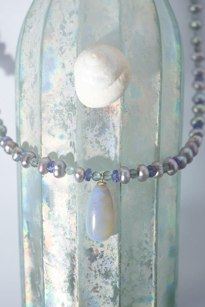 Misty grey, periwinkle blue, aquamarine and a luminous Australian opal come together to create an ethereal gemstone necklace.