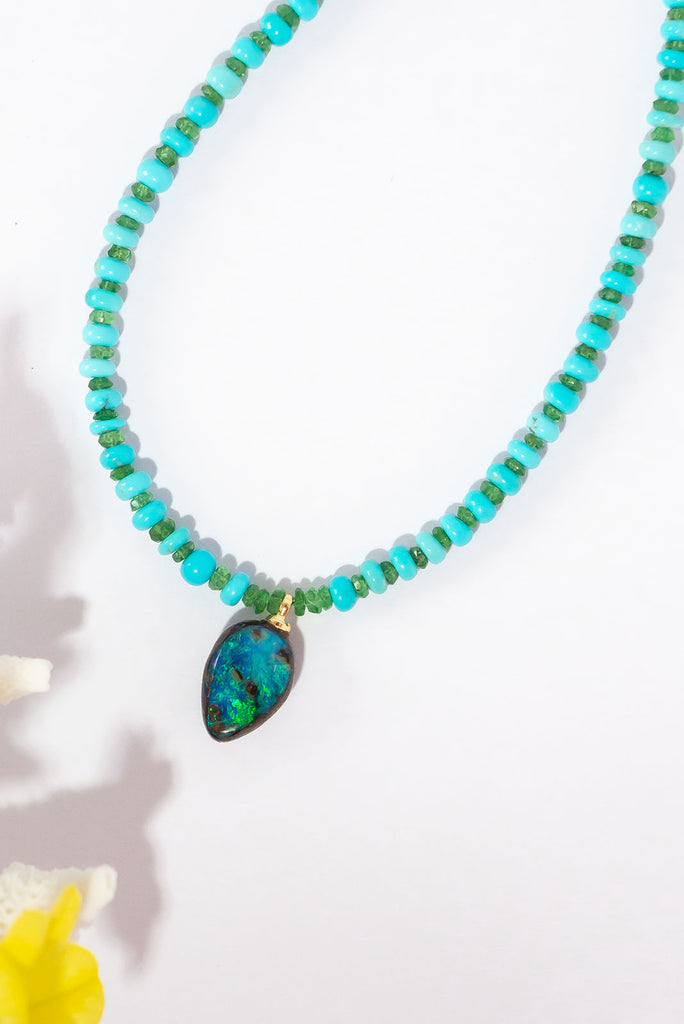 Inspired by the colours of a beautiful tropical paradise. This stunning opal is complimented beautifully by sky blue turquoise and apple green tsavorite.