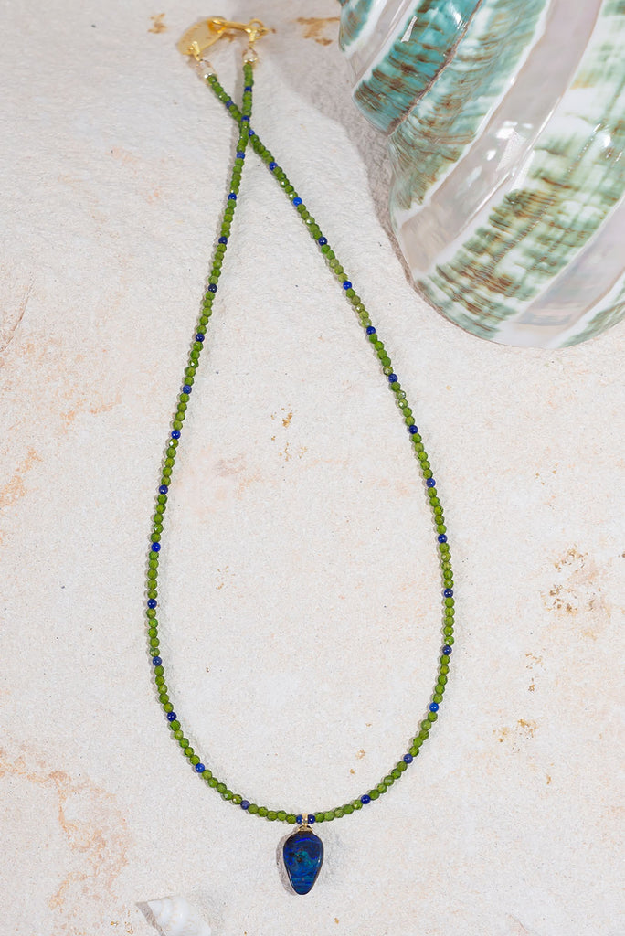 This delicate gemstone necklace features showing stopping jewel tones and a petite boulder opal pendant.