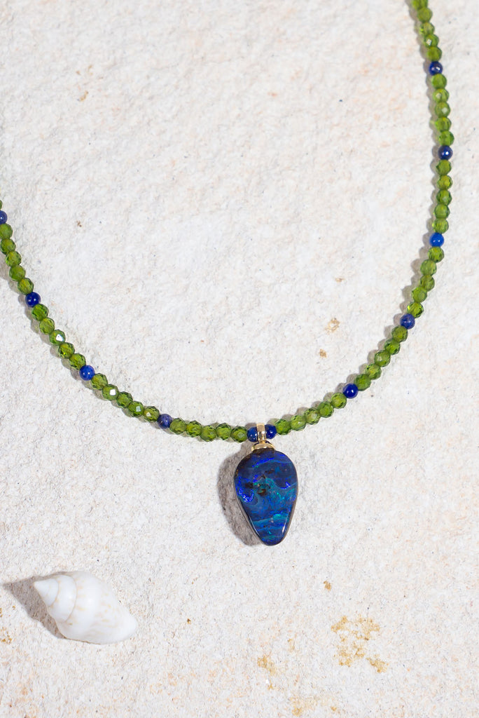 This delicate gemstone necklace features showing stopping jewel tones and a petite boulder opal pendant.