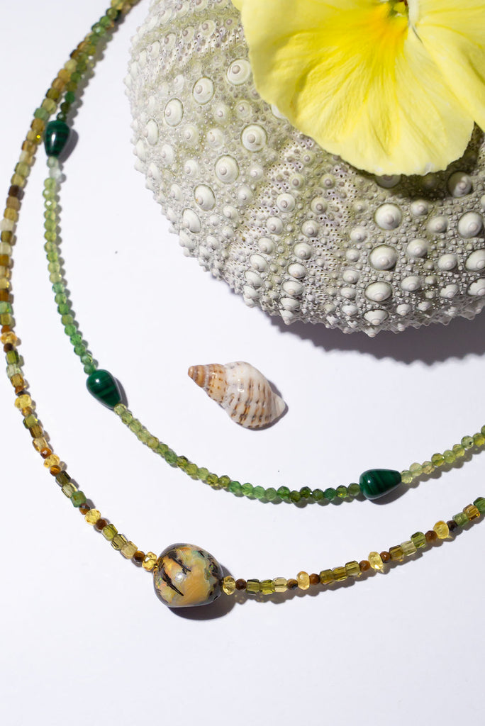 Soft warm green tones and a unique Australian boulder opal bead make this delicate piece something special.