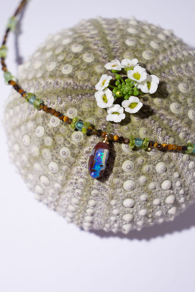 Slivers of bright blue sky, lush green foliage and the damp warm earth of a tropical rainforest. The gorgeous Necklace Gemstone Rainforest Dreams is reminiscent of our beautiful tropical north Queensland.