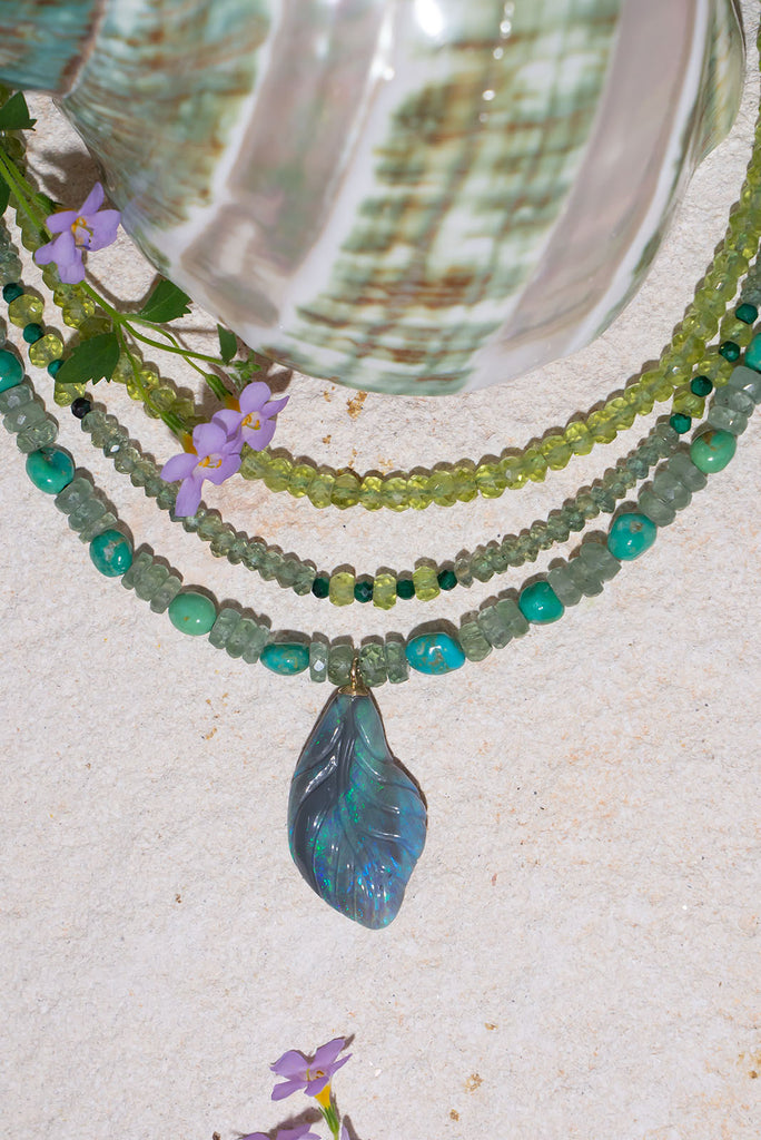 This gorgeous sea green toned necklace will have you spell bound. Featuring a unique hand carved solid opal leaf pendant this is a very special piece.