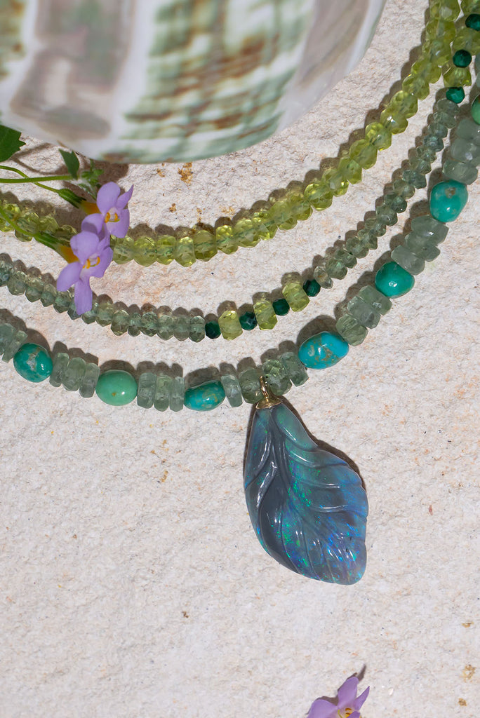 This gorgeous sea green toned necklace will have you spell bound. Featuring a unique hand carved solid opal leaf pendant this is a very special piece.