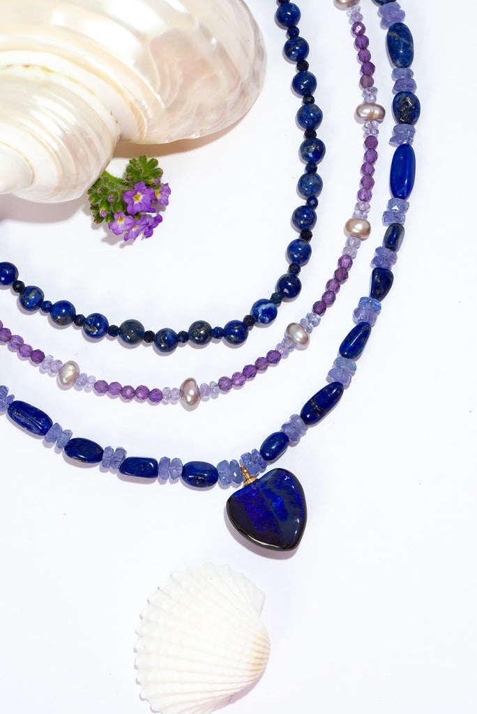 Fall in love with the deep jewel tones of this magical gemstone &amp; opal necklace. Deep blue lapis lazuli and shimmering tanzanite beautiful compliment the dark blue and purple fire found in the gorgeous Australian boulder opal heart pendant.